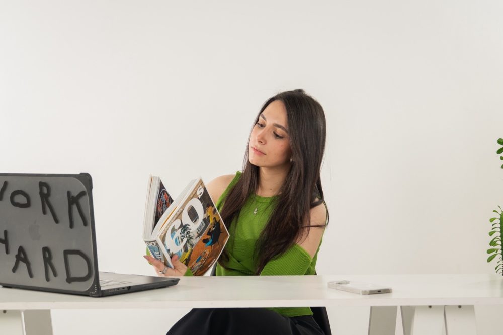 Reading a book of 1960s advertising at the desk